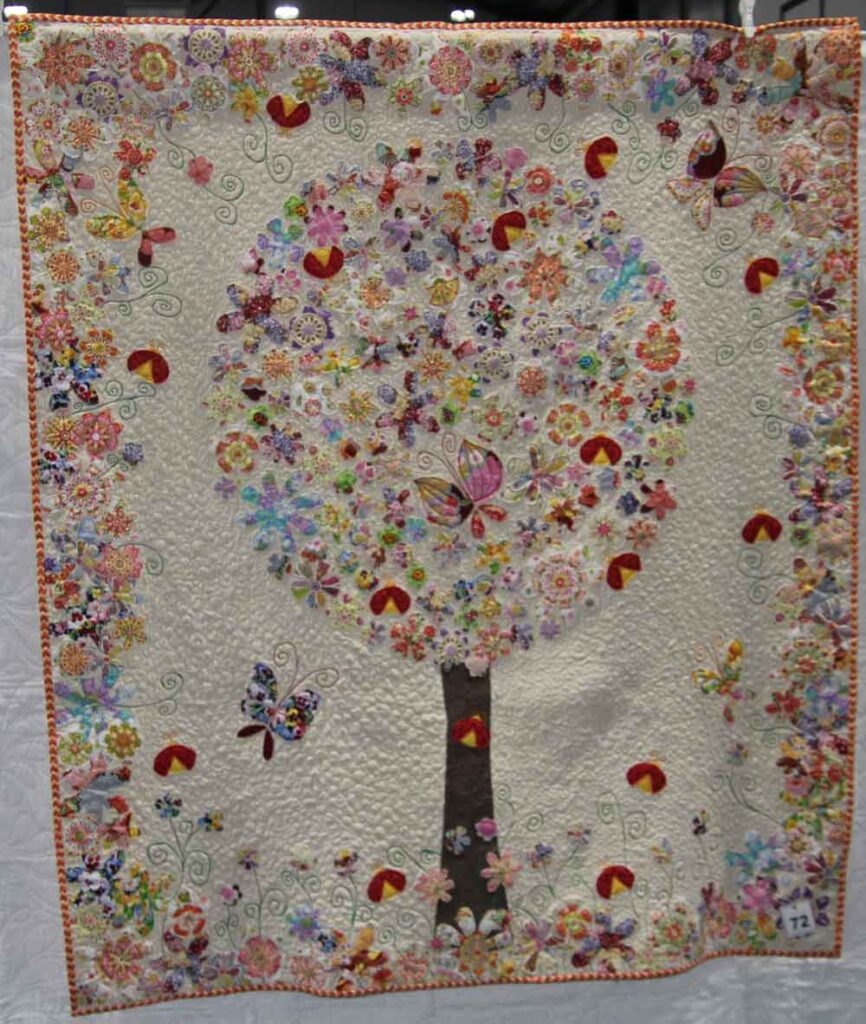 Beautiful quilt of tree with flowers and butterflies